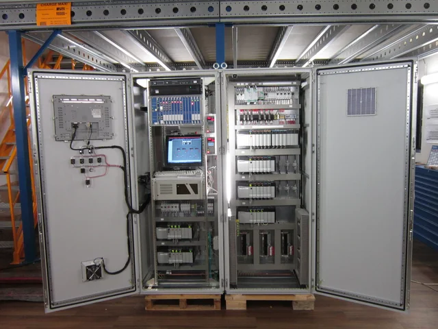 Industrial automation control cabinet with PLC racks, wire ducts, and power distribution